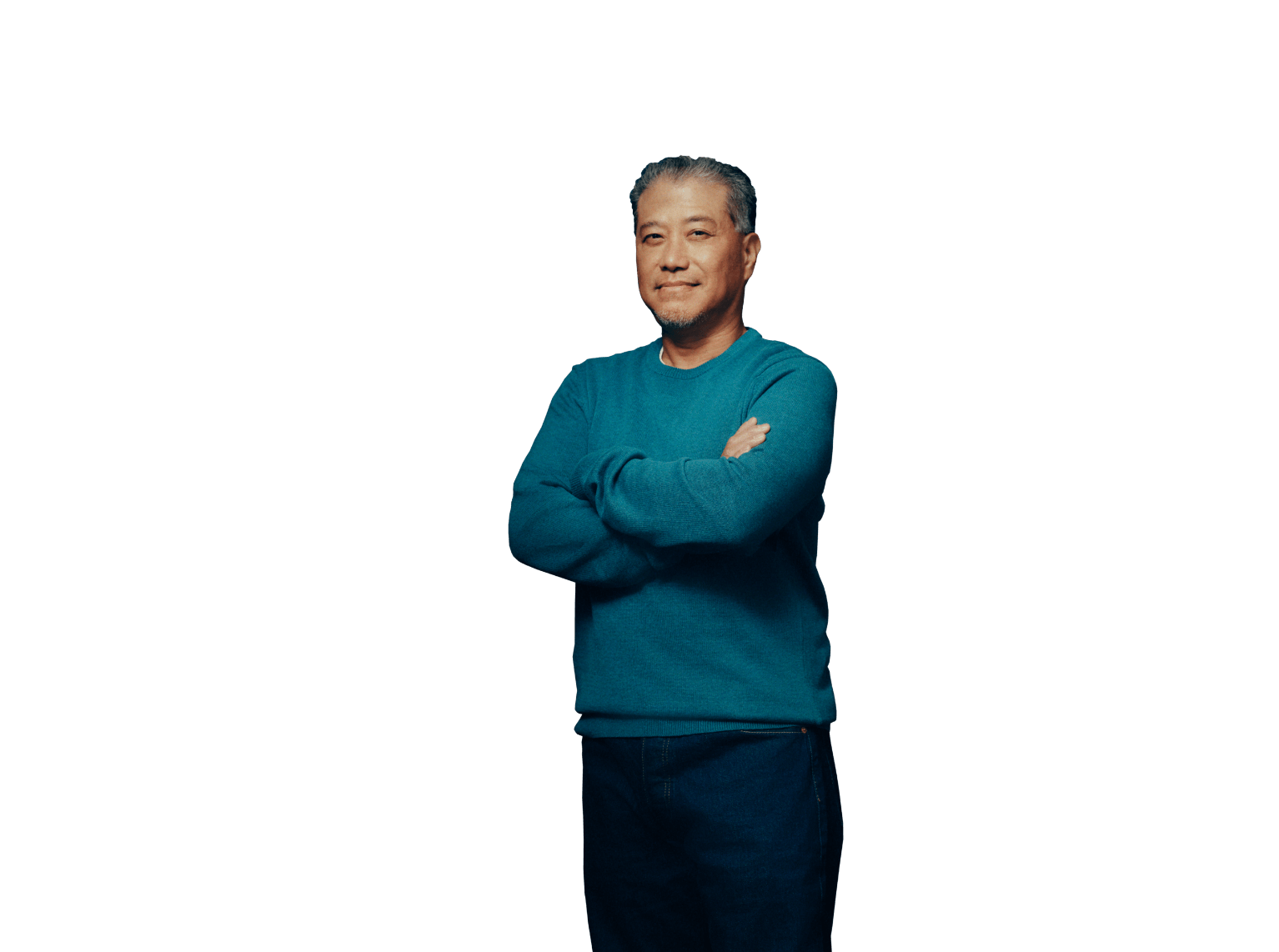 Middle aged man smiling at camera with arms folded across chest. Not actual patient.