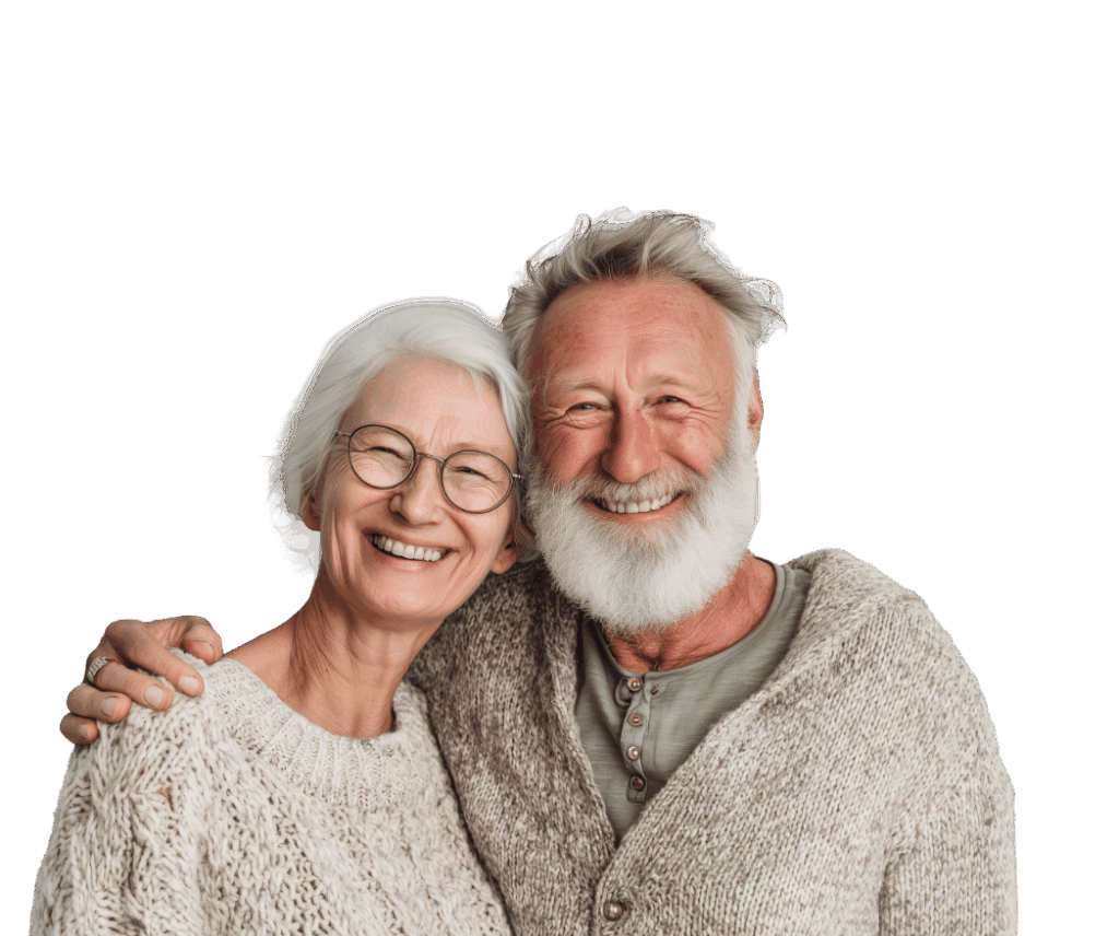 Happy senior couple embracing and smiling warmly: elderly woman with white hair, round glasses, and light knitted sweater, arm around elderly man with long white beard, wearing beige cardigan over green shirt, both laughing joyfully against black background